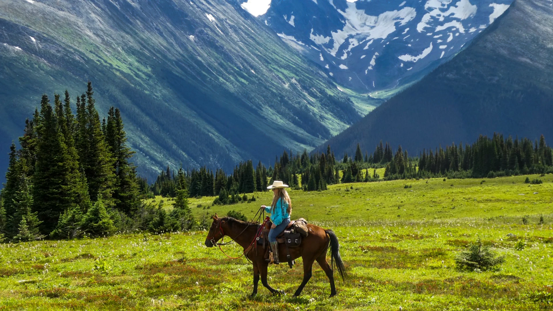 Horseback riding in front of a mountain