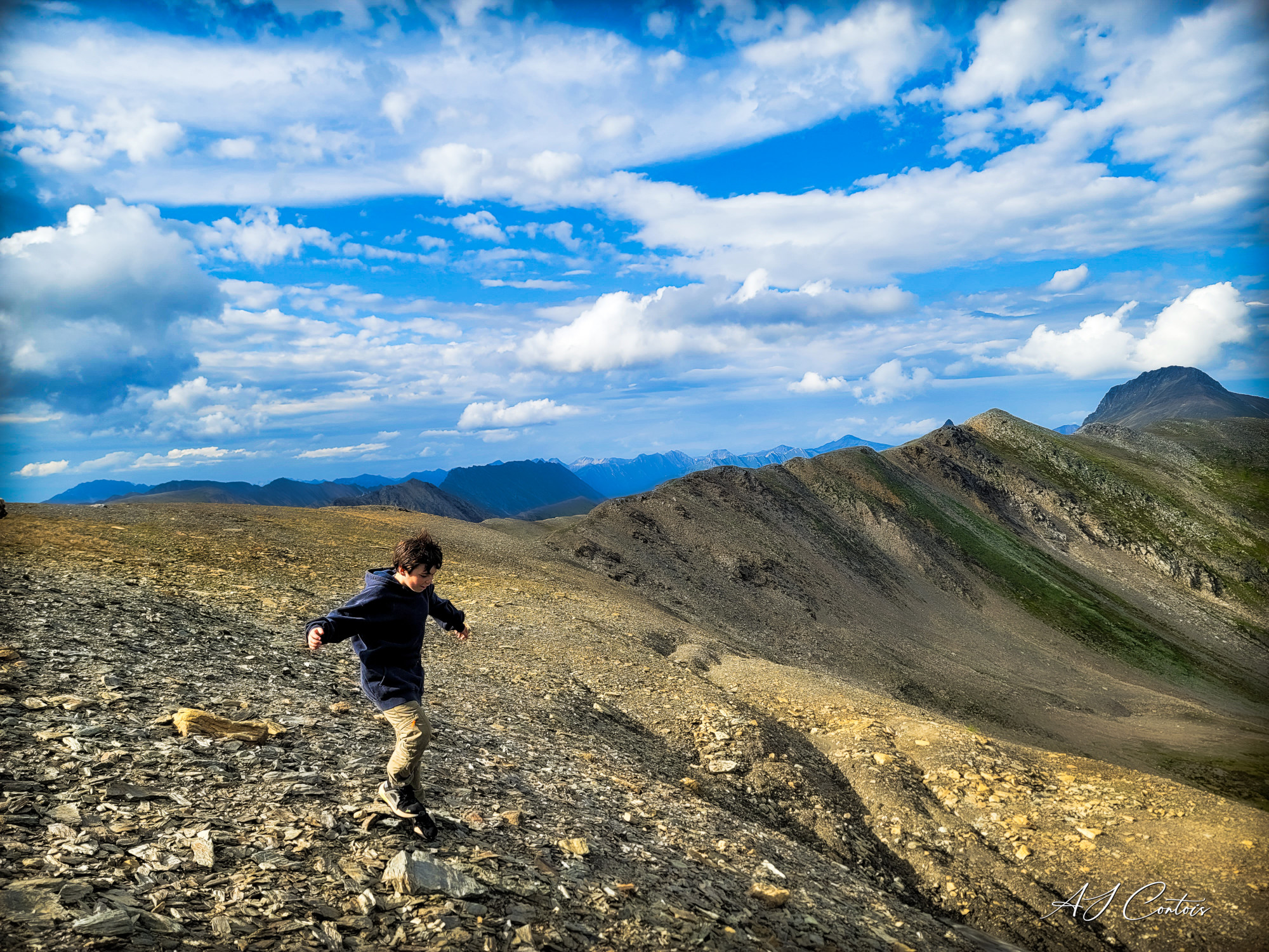 A person standing on a rocky peak in McBride